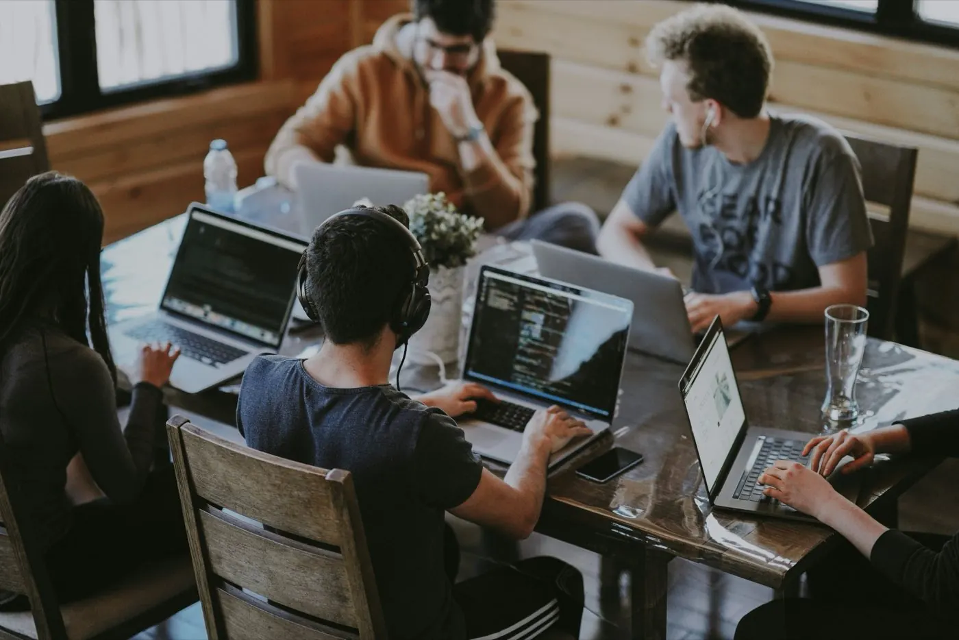 A startup team working together at laptops around a shared table