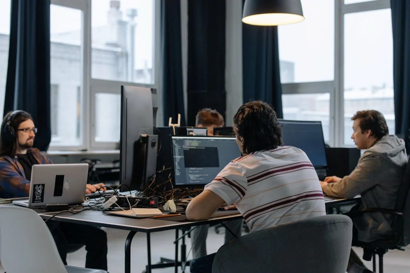 A startup engineering team working at their desks in an open office